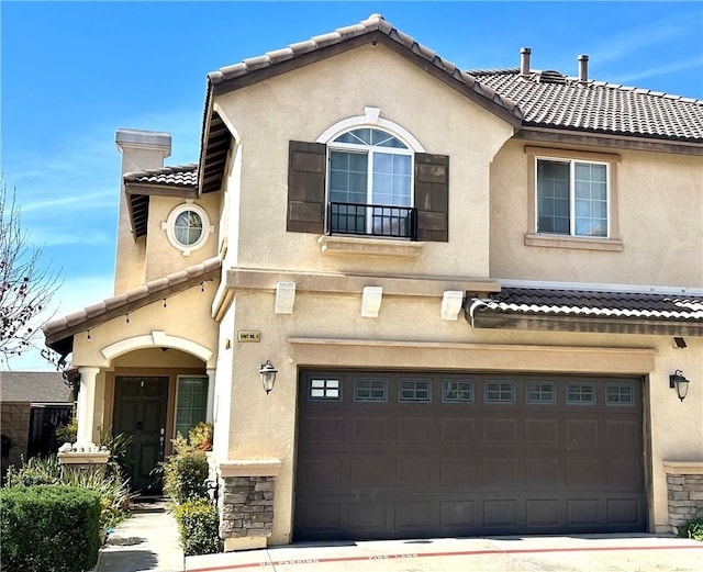 view of front of home featuring an attached garage and stucco siding