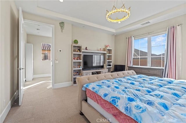 bedroom featuring light colored carpet, a raised ceiling, visible vents, and baseboards