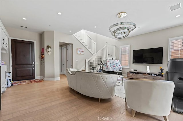 living area with light wood-style floors, stairs, visible vents, and recessed lighting