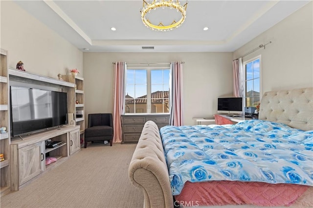 bedroom featuring light carpet, a raised ceiling, and recessed lighting