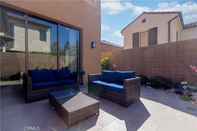 view of patio with fence and an outdoor hangout area