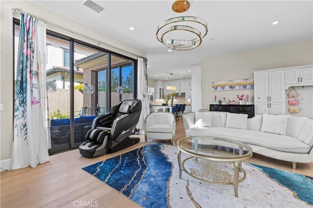 living room featuring light wood finished floors, visible vents, and recessed lighting