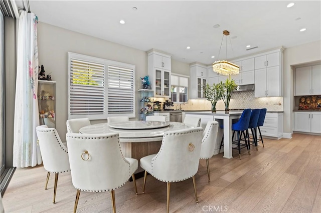 dining room featuring light wood-type flooring and recessed lighting