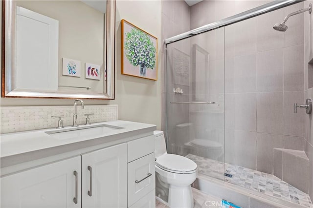 full bath featuring a shower stall, vanity, and toilet