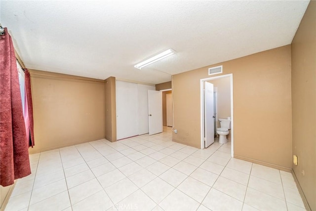 spare room with visible vents and light tile patterned floors