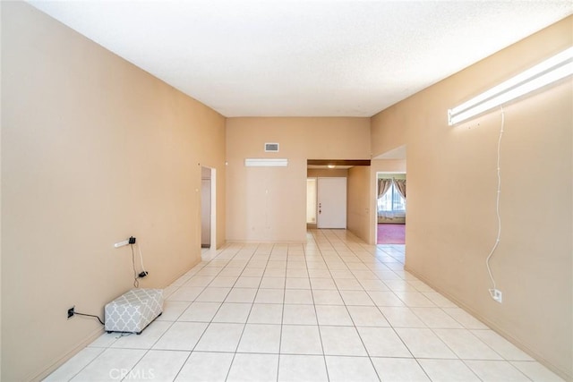 spare room featuring visible vents and light tile patterned floors