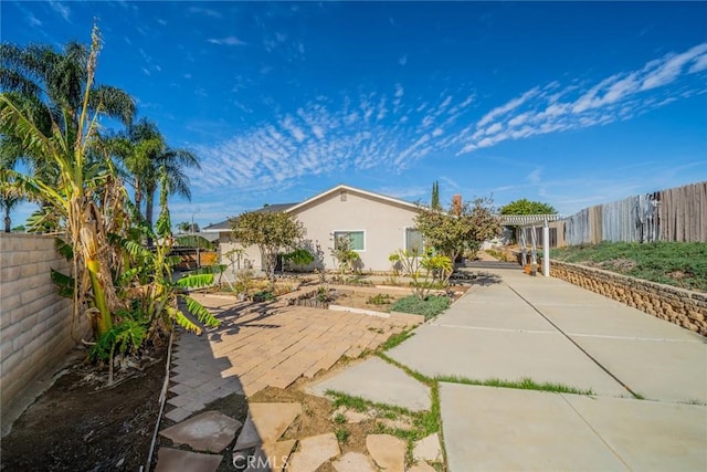 exterior space with a fenced backyard, a patio, and stucco siding