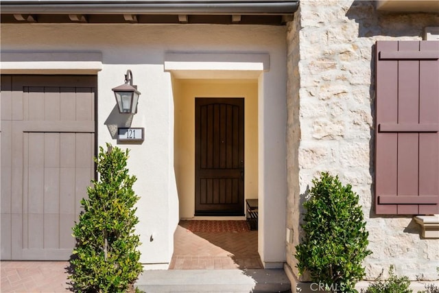 doorway to property with stucco siding