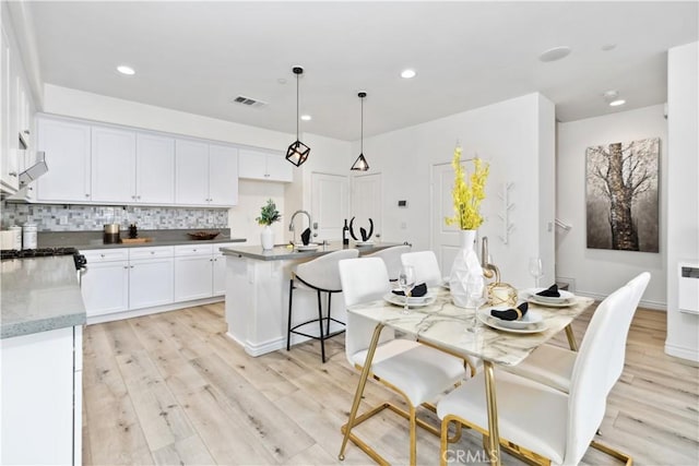 dining room with recessed lighting, visible vents, and light wood finished floors