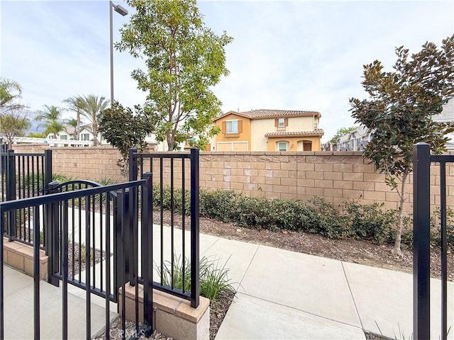 view of gate with a fenced front yard