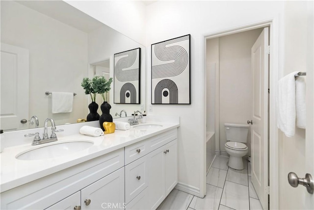 full bathroom with double vanity, a bathing tub, toilet, and a sink