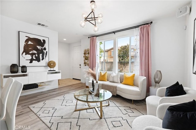 interior space featuring recessed lighting, visible vents, a notable chandelier, and wood finished floors