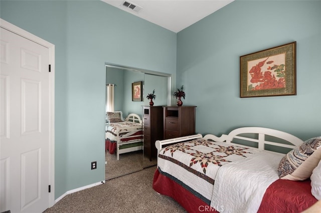 carpeted bedroom featuring visible vents and baseboards