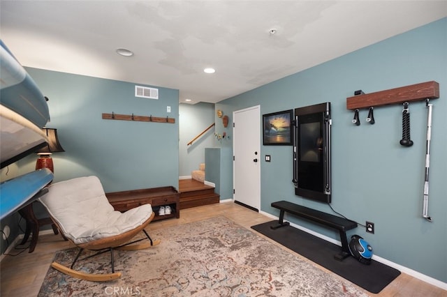 sitting room with stairs, recessed lighting, visible vents, and baseboards