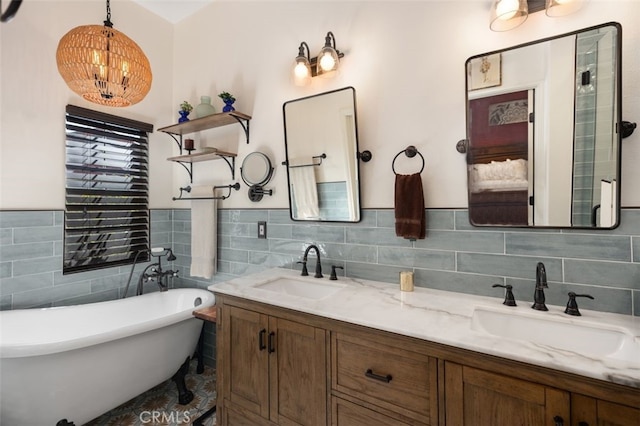 bathroom with a soaking tub, a sink, tile walls, and double vanity