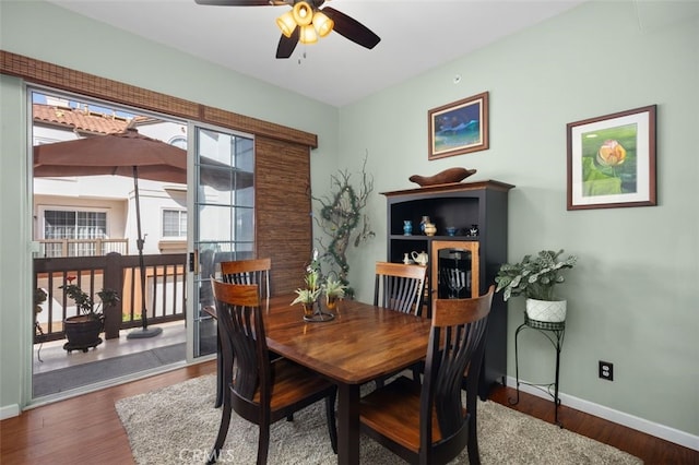 dining area with ceiling fan, baseboards, and wood finished floors