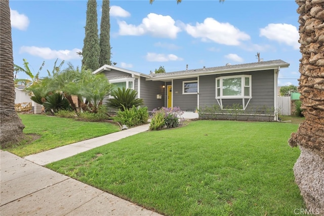 single story home featuring a front lawn