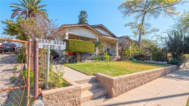 view of front of property featuring a front lawn and fence