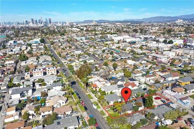 birds eye view of property with a view of city, a mountain view, and a residential view