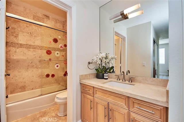 bathroom featuring toilet, shower / bath combination with glass door, tile patterned flooring, and vanity