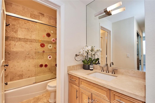 full bath with toilet, tile patterned floors, combined bath / shower with glass door, and vanity