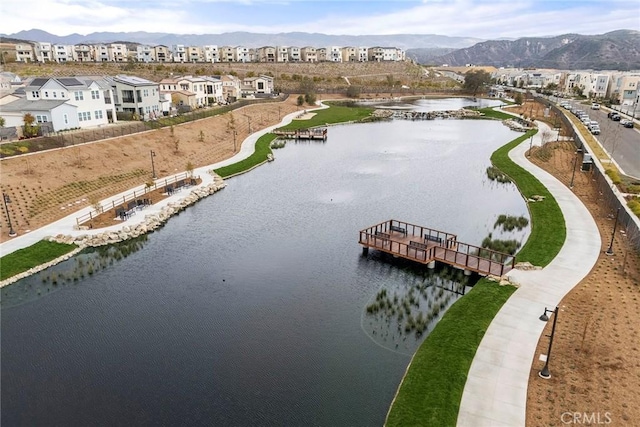 drone / aerial view featuring a water and mountain view