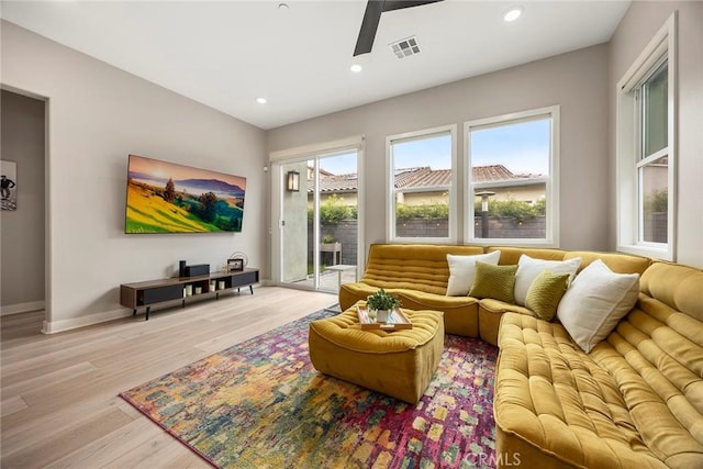 living area with recessed lighting, visible vents, a ceiling fan, light wood-type flooring, and baseboards