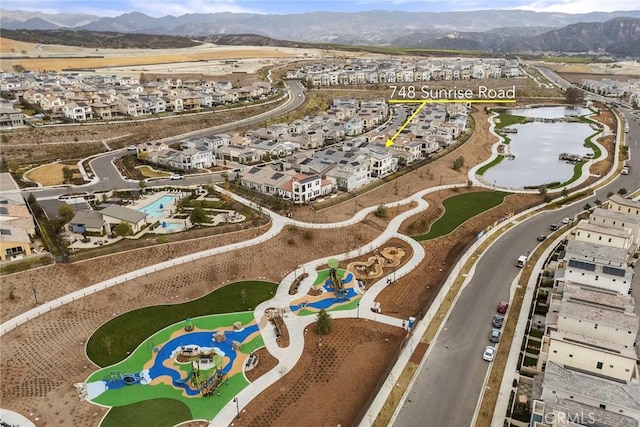 drone / aerial view featuring a residential view and a mountain view