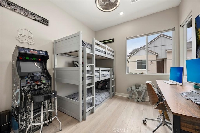 bedroom with light wood-style floors and baseboards