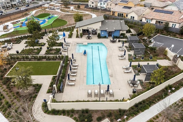 community pool featuring a patio area and a residential view