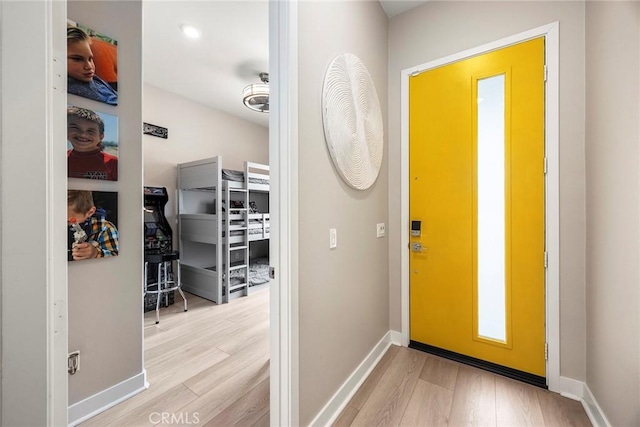 entryway with baseboards and light wood-style floors