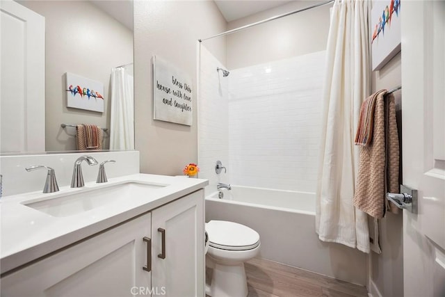 full bathroom featuring toilet, wood finished floors, vanity, and shower / tub combo with curtain