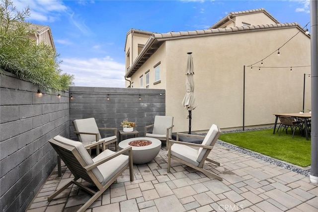 view of patio / terrace with an outdoor fire pit and a fenced backyard