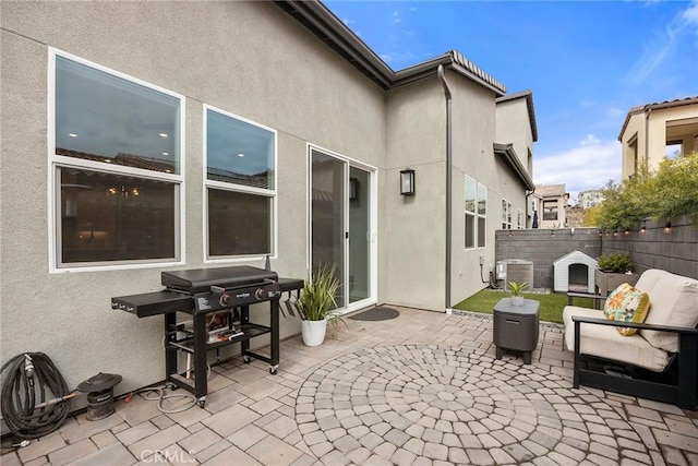 view of patio / terrace with cooling unit, a fireplace, fence, and grilling area