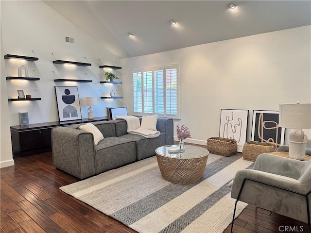 living room featuring dark wood-style floors, lofted ceiling, visible vents, and baseboards