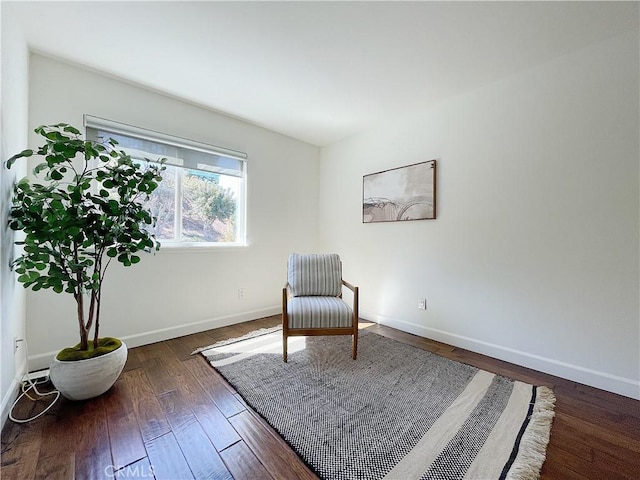 unfurnished room featuring baseboards and dark wood-style flooring