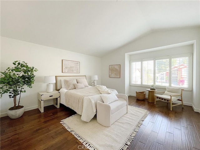 bedroom with lofted ceiling, dark wood-style flooring, and baseboards