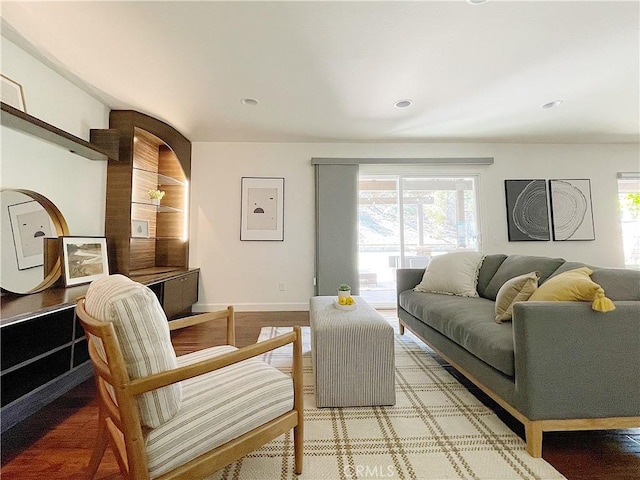 living room featuring baseboards and recessed lighting