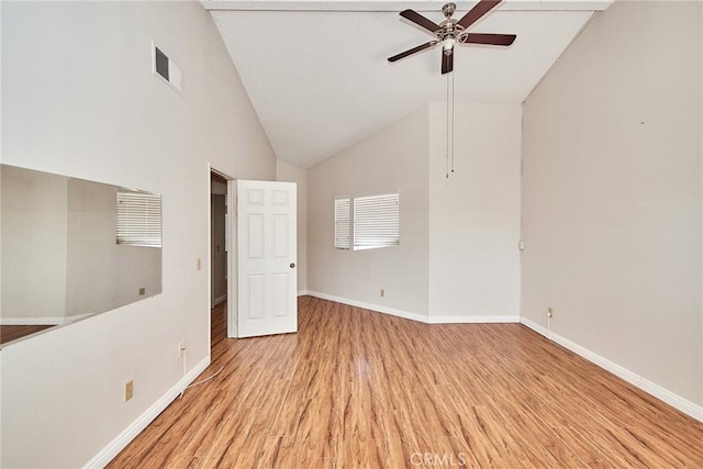 unfurnished bedroom featuring lofted ceiling, visible vents, ceiling fan, light wood-type flooring, and baseboards