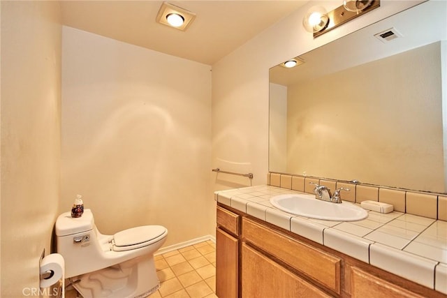 bathroom with tile patterned flooring, toilet, visible vents, vanity, and baseboards