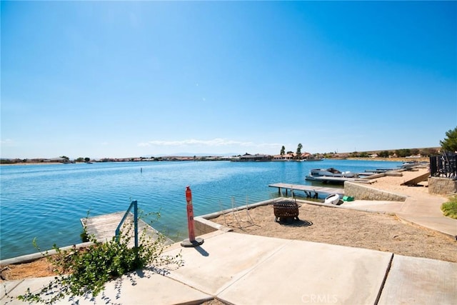 property view of water with a dock and a fire pit