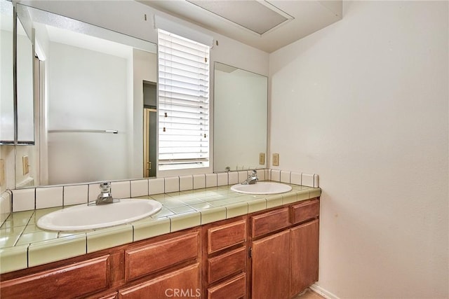 full bathroom with double vanity and a sink