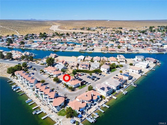 drone / aerial view featuring a water view and a residential view