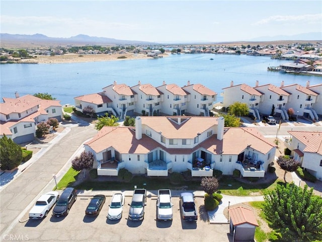 drone / aerial view with a water view and a residential view