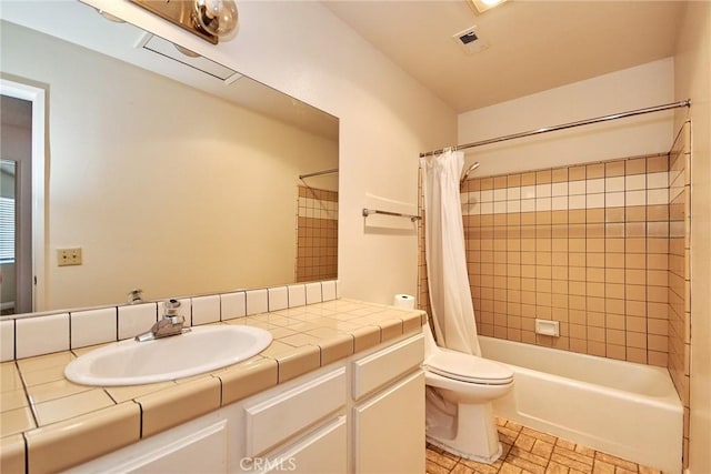 bathroom with toilet, visible vents, shower / tub combo with curtain, and vanity