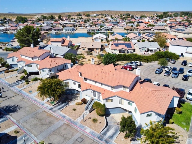 drone / aerial view featuring a water view and a residential view