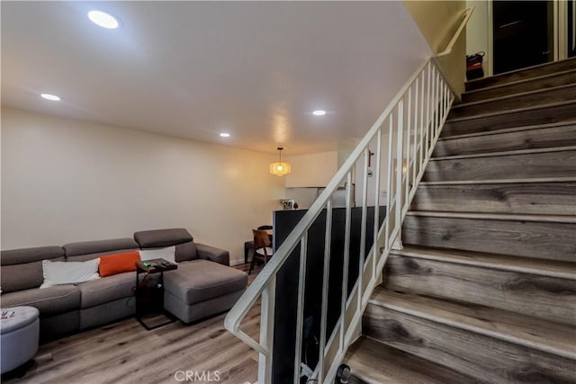 staircase with recessed lighting and wood finished floors