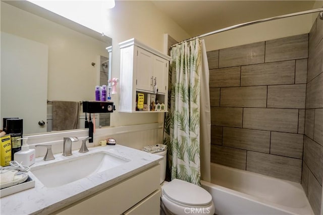 bathroom with shower / tub combo with curtain, vanity, and toilet