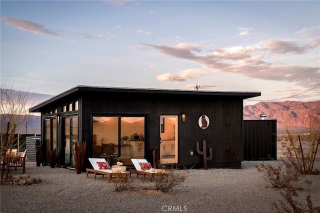 back of property featuring a mountain view