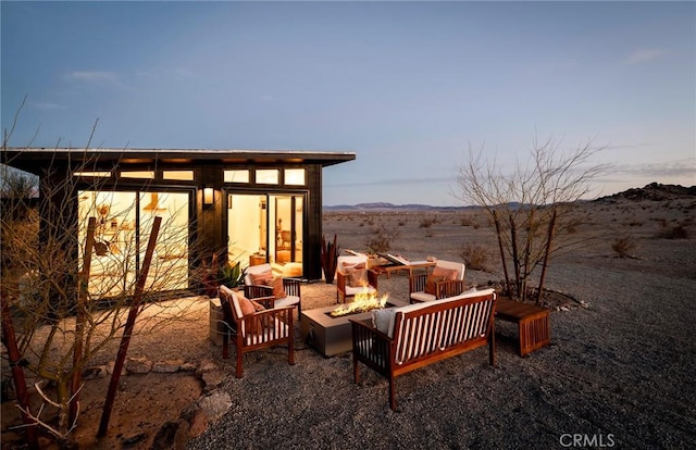 view of patio featuring an outdoor fire pit and a mountain view